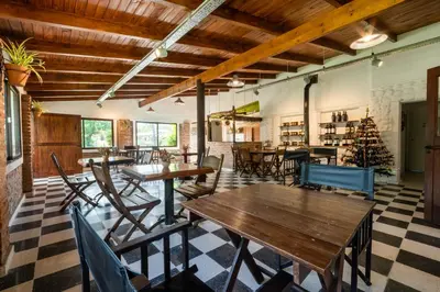 a restaurant with tables and chairs and a christmas tree at Los Sauces Posada in Nono