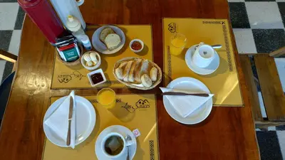 a table with breakfast foods and coffee on it at Los Sauces Posada in Nono