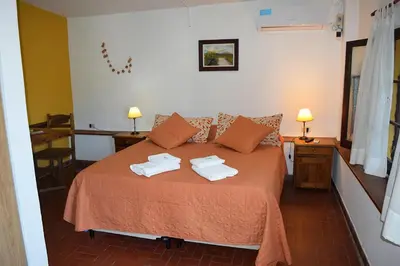 a bedroom with a bed with towels on it at Los Sauces Posada in Nono