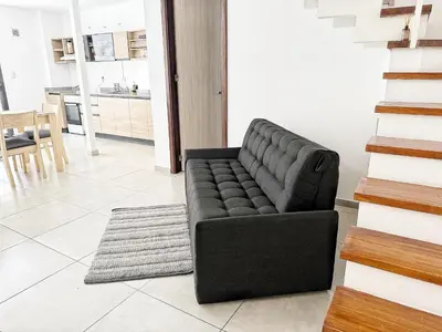 a black couch sitting in a living room at PASEO QUATTRO in Villa Carlos Paz