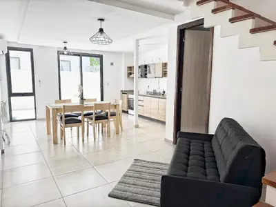 a living room with a couch and a table at PASEO QUATTRO in Villa Carlos Paz