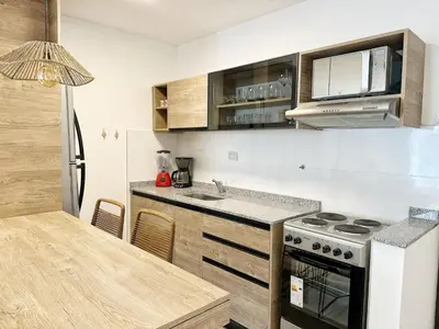 a kitchen with a sink and a stove top oven at PASEO QUATTRO in Villa Carlos Paz