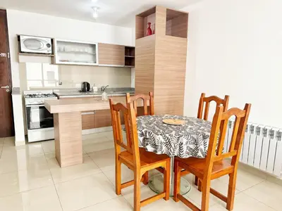 a kitchen with a dining room table and chairs at PASEO QUATTRO in Villa Carlos Paz