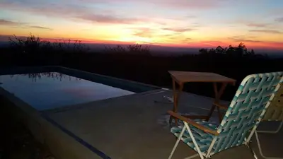 a chair and a table next to a swimming pool at LUMAFACA in La Población