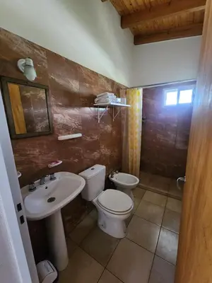 a bathroom with a toilet and a sink at Complejo Cielo Azul in Villa Rumipal