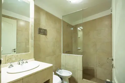 a bathroom with a sink and a toilet and a shower at Aguas Claras Hosteria in Santa Rosa de Calamuchita