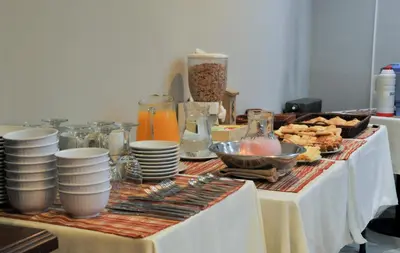 a table topped with plates and bowls of food at Aguas Claras Hosteria in Santa Rosa de Calamuchita