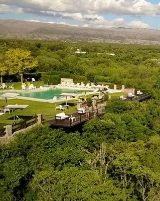 an aerial view of a resort with a swimming pool at Balcón del Río, Hotel de Campo y Cabañas in Mina Clavero