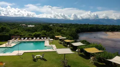 a swimming pool with a view of a mountain at Balcón del Río, Hotel de Campo y Cabañas in Mina Clavero