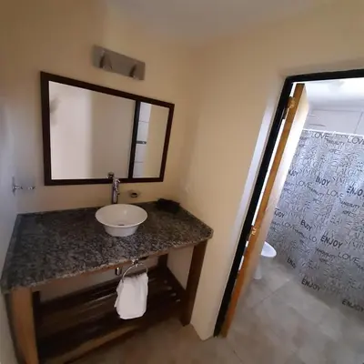 a bathroom with a sink and a mirror at Piscu Yaco in Santa Rosa de Calamuchita