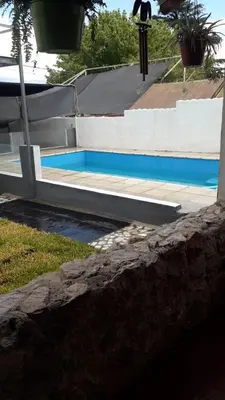 a swimming pool in front of a house at Doña Aida in Mina Clavero