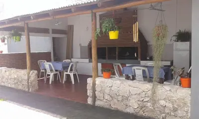 a restaurant with tables and chairs on a patio at Doña Aida in Mina Clavero