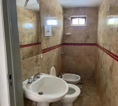 a bathroom with a sink and a toilet at Doña Aida in Mina Clavero