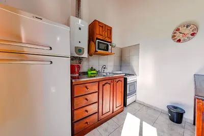 a kitchen with a refrigerator and a sink at La Querencia in Villa Carlos Paz