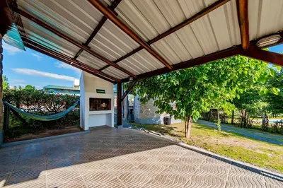 an open patio with a hammock in a house at La Querencia in Villa Carlos Paz