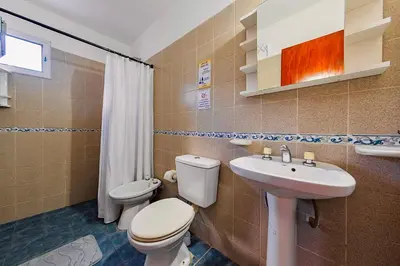 a bathroom with a toilet and a sink at La Querencia in Villa Carlos Paz
