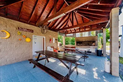 a patio with a wooden table and benches at La Querencia in Villa Carlos Paz