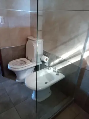 a bathroom with a toilet and a sink at Cabaña Azul in Villa Anizacate