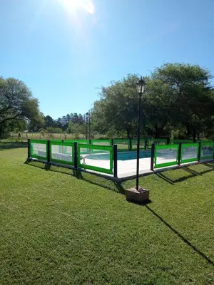 a park bench with a light pole in the grass at Cabaña Azul in Villa Anizacate
