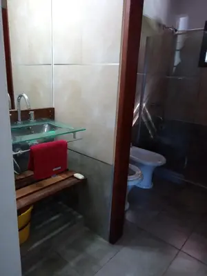 a bathroom with a sink and a toilet at Cabaña Azul in Villa Anizacate