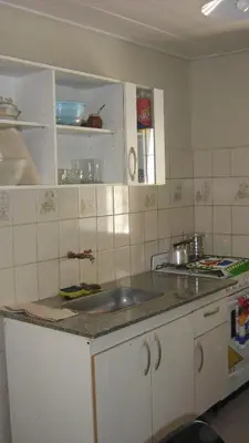 a kitchen with a sink and a counter top at La Guadalupana in Mina Clavero