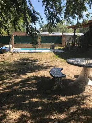a picnic table in a park under a tree at Complejo Norte in Merlo
