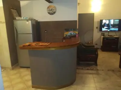 a kitchen with a counter top and a refrigerator at Complejo Norte in Merlo