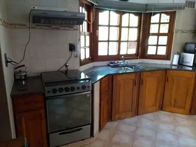 a kitchen with a stove and a sink at Complejo Norte in Merlo