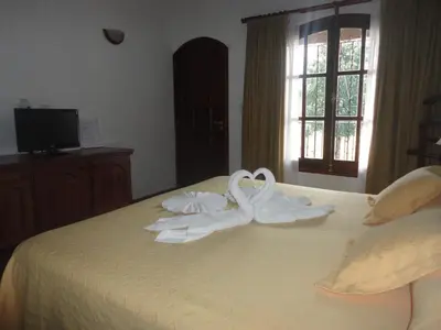 two swan towels on a bed in a bedroom at El Cortijo Apart - Hotel in Merlo