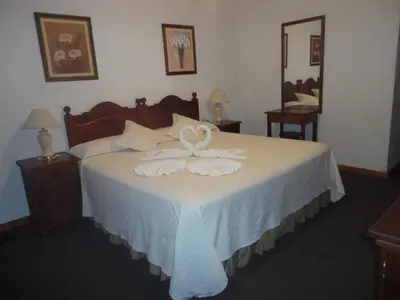 a bedroom with a bed with two towels on it at El Cortijo Apart - Hotel in Merlo