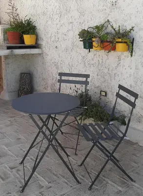a table and two chairs sitting next to a wall at Departamento Fragueiro 2414 terraza exclusiva in Cordoba