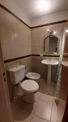 a bathroom with a toilet and a sink at Departamento Fragueiro 2414 terraza exclusiva in Cordoba