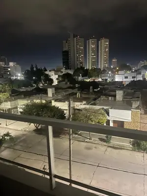 a view of a city at night with tall buildings at CALIDO-Departamento 1 dormitorio amueblado excelente ubicacion in Río Cuarto