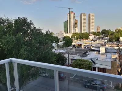 a balcony with a view of a city with tall buildings at CALIDO-Departamento 1 dormitorio amueblado excelente ubicacion in Río Cuarto