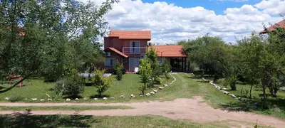 a house with a garden in front of it at Ayres Serranos in Merlo