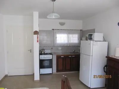 a kitchen with a white refrigerator and a stove at Ayres Serranos in Merlo