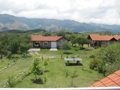 a garden with a bench in front of a house at Ayres Serranos in Merlo