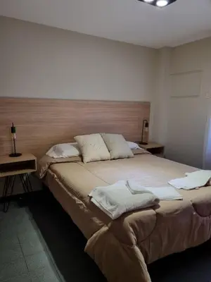 a bedroom with a large bed with two pillows at Alquiler Temporario en Nueva Córdoba! in Cordoba