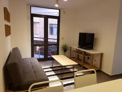 a living room with a couch and a television at Alquiler Temporario en Nueva Córdoba! in Cordoba