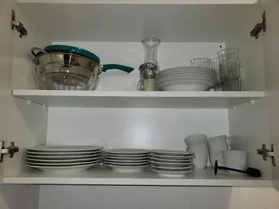 a shelf with plates and bowls and other dishes at Alquiler Temporario en Nueva Córdoba! in Cordoba