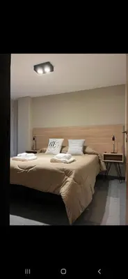 a bedroom with a large bed with two pillows at Alquiler Temporario en Nueva Córdoba! in Cordoba