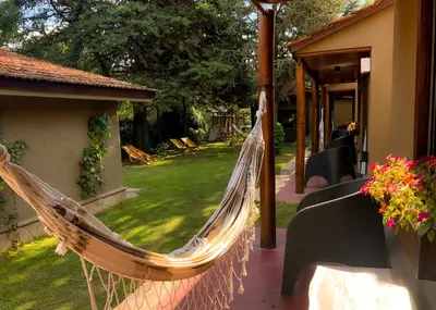 a hammock hanging outside of a house with a yard at Mont Blanc in Villa General Belgrano