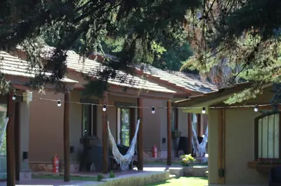 a group of hammocks hanging from a building with lights at Mont Blanc in Villa General Belgrano