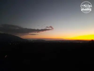 a sunset with the sun setting in the horizon at Cabaña de Montaña, La Casita Mina Clavero CBA in Mina Clavero