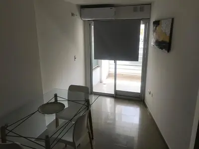 a glass table and chair in a room with a window at Jardines del Boulevard 3, Nueva cordoba in Cordoba