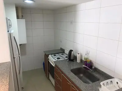 a small kitchen with a sink and a stove at Jardines del Boulevard 3, Nueva cordoba in Cordoba