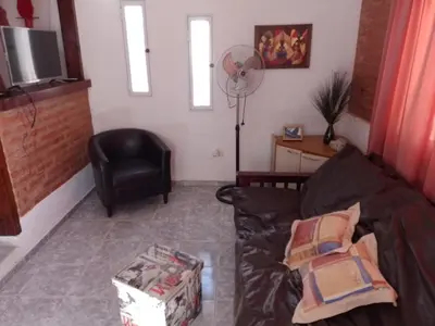 a living room with a couch and a chair at Mini Complejo Familiar Roque in Mina Clavero
