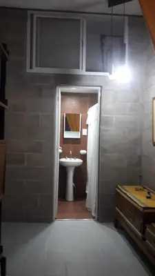 a bathroom with a sink and a toilet in it at Mini Complejo Familiar Roque in Mina Clavero