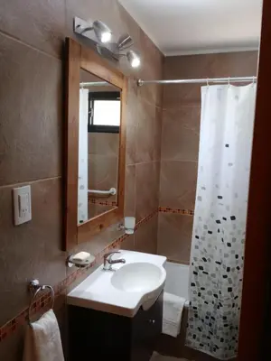 a bathroom with a sink and a shower at Complejo Cerro Negro VGB in Villa General Belgrano
