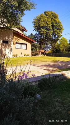 a house in a yard with a driveway at Complejo Cerro Negro VGB in Villa General Belgrano
